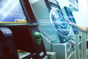 Hand reaching out using a touch screen of a piece of fintech supplied by NCR dealers