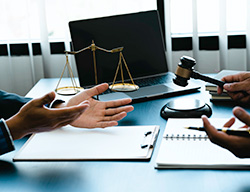 Business owner and lawyer discussing neglect of NJ fire alarm service