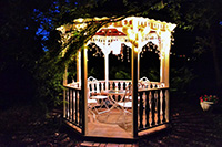 Gazebo at night with lights around top built by North Beach deck builders